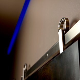 Inspiration for a medium sized contemporary enclosed home cinema in Other with grey walls, bamboo flooring and a projector screen.