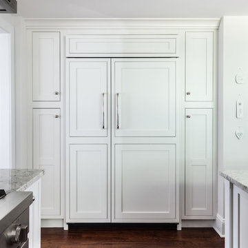 Paneled Refrigeration - flanked with pull out pantries