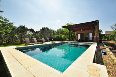 Pool house - large contemporary backyard concrete and rectangular lap pool house idea in Austin
