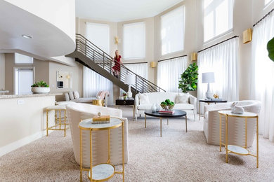 Contemporary open concept living room in Orange County with beige walls, carpet and beige floor.