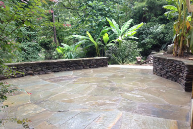Irregular flagstone patio and dry stack PA stone retaining wall