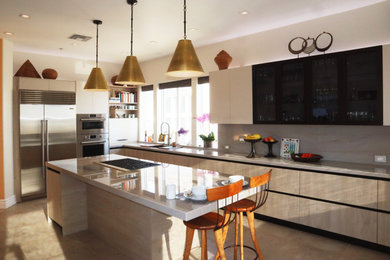 Large trendy u-shaped porcelain tile and beige floor enclosed kitchen photo in Los Angeles with an undermount sink, flat-panel cabinets, light wood cabinets, quartzite countertops, beige backsplash, stone slab backsplash, stainless steel appliances, an island and beige countertops