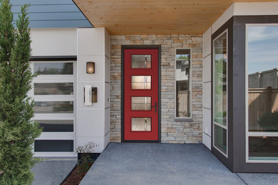 Minimalist concrete floor single front door photo in Tampa with a red front door