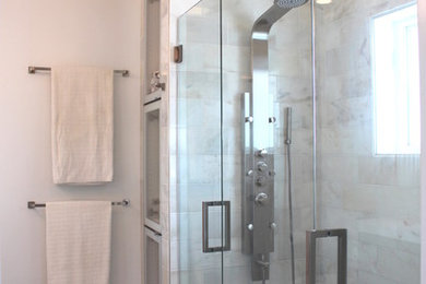 Example of a mid-sized trendy master white tile and stone tile marble floor double shower design in New York with a wall-mount sink, flat-panel cabinets, dark wood cabinets, a one-piece toilet and white walls