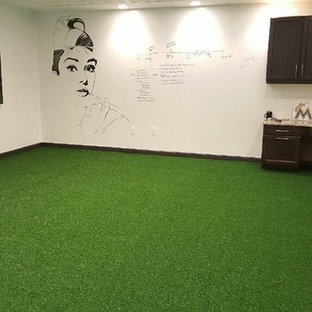 Design ideas for a medium sized modern study in Tampa with white walls, no fireplace, a built-in desk and green floors.