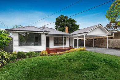 Design ideas for a large scandinavian one-storey white house exterior in Melbourne with wood siding, a metal roof and a grey roof.