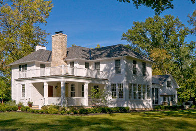 This is an example of a large traditional two-storey white exterior in Columbus with wood siding and a hip roof.