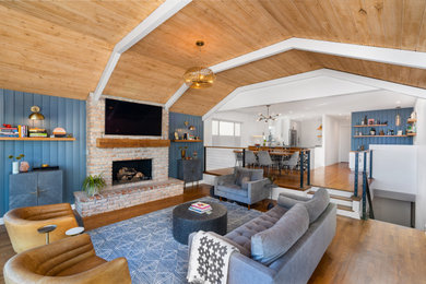 Living room - coastal open concept vaulted ceiling, shiplap wall, dark wood floor and multicolored floor living room idea in Portland with blue walls and a brick fireplace