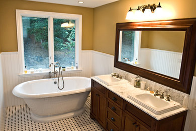 Freestanding bathtub - mid-sized cottage master ceramic tile and white floor freestanding bathtub idea in San Luis Obispo with recessed-panel cabinets, dark wood cabinets, yellow walls, a drop-in sink, quartzite countertops and white countertops