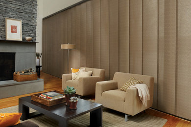 Family room - contemporary light wood floor and beige floor family room idea in Vancouver with beige walls, a standard fireplace and a concrete fireplace