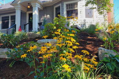 This is an example of a mid-sized craftsman drought-tolerant, full sun and rock front yard landscaping in Portland for summer.