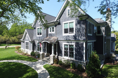 Large arts and crafts blue three-story wood exterior home photo in Chicago
