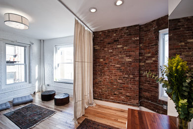 Example of a trendy medium tone wood floor living room design in New York