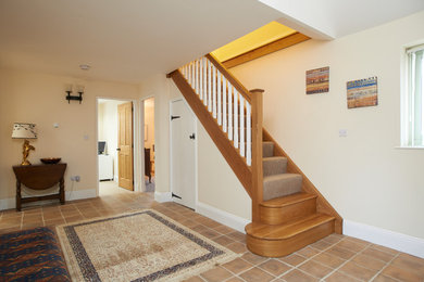 Inspiration for a medium sized country hallway in Other with red floors.