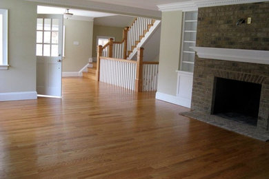 Example of a large transitional open concept medium tone wood floor living room design in Richmond with beige walls, a standard fireplace and a brick fireplace