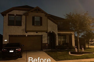 Inspiration for a timeless beige two-story stone house exterior remodel in Houston with a hip roof and a shingle roof