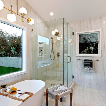 Soaker Tub Freestanding in Master Bath with Brass Light Fixtures