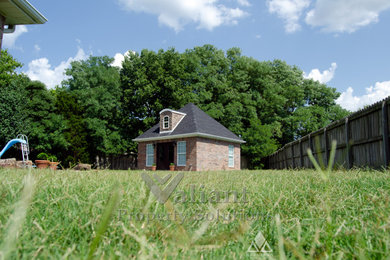 Inspiration for a small red one-story brick exterior home remodel in Other