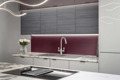 Inspiration for a large contemporary grey and purple single-wall kitchen in Other with flat-panel cabinets, beige cabinets, quartz worktops, glass sheet splashback, black appliances, ceramic flooring, an island, multi-coloured floors, multicoloured worktops and feature lighting.