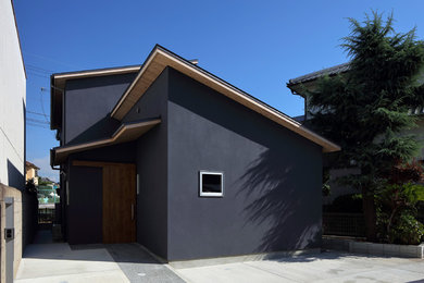 Design ideas for an asian two-storey blue house exterior in Osaka with a shed roof and a metal roof.