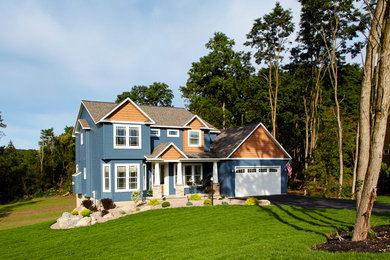 Blue two-story vinyl and clapboard exterior home photo in Other with a shingle roof and a brown roof