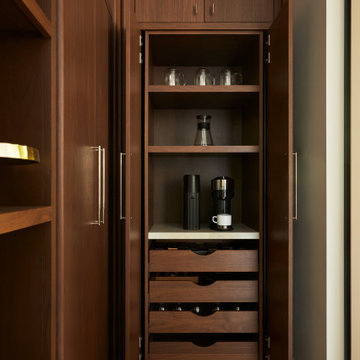 Walnut Pocket Doors Unveil a Stylish Kitchen Pantry Coffee Station