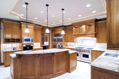 Example of a mid-sized classic u-shaped ceramic tile and white floor eat-in kitchen design in San Francisco with a drop-in sink, open cabinets, stainless steel cabinets, beige backsplash, mosaic tile backsplash, stainless steel appliances, an island and granite countertops