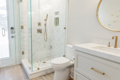 This is an example of a small traditional shower room bathroom in Dallas with recessed-panel cabinets, beige cabinets, a corner shower, a one-piece toilet, beige tiles, porcelain tiles, beige walls, marble flooring, a submerged sink, engineered stone worktops, beige floors, a hinged door, white worktops, a single sink and a built in vanity unit.