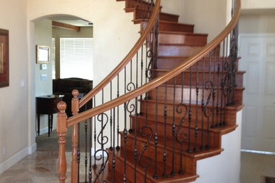 This is an example of a large traditional wood curved staircase in San Francisco with wood risers.