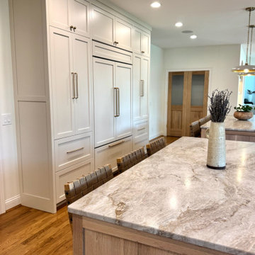 Frameless white perimeter with rift cut oak islands