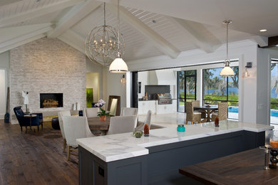 Family room - large contemporary open concept dark wood floor and brown floor family room idea in Orlando with white walls, a standard fireplace, a stone fireplace and no tv