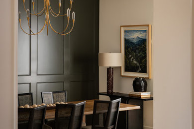 Inspiration for a transitional light wood floor and wall paneling dining room remodel in Orange County with green walls