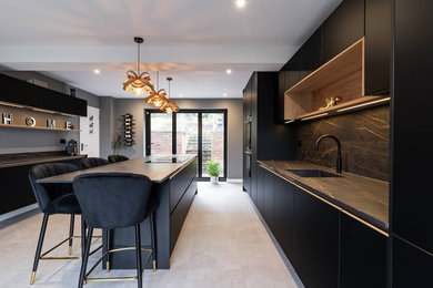 Design ideas for a large modern galley open plan kitchen in Buckinghamshire with a single-bowl sink, flat-panel cabinets, black cabinets, quartz worktops, black splashback, black appliances, an island, black worktops and exposed beams.