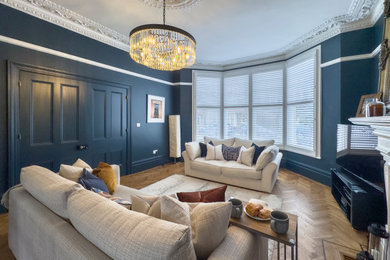 Small classic open plan living room in Other with blue walls, medium hardwood flooring, a wood burning stove and no tv.
