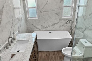 Inspiration for a modern single-sink bathroom remodel in Los Angeles with marble countertops and a built-in vanity