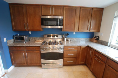 Large elegant u-shaped porcelain tile open concept kitchen photo in Orange County with a double-bowl sink, recessed-panel cabinets, medium tone wood cabinets, granite countertops, gray backsplash, stone slab backsplash, stainless steel appliances and no island