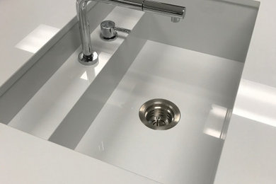 Example of a mid-sized trendy eat-in kitchen design in Seattle with an integrated sink, flat-panel cabinets, gray cabinets, an island and white countertops
