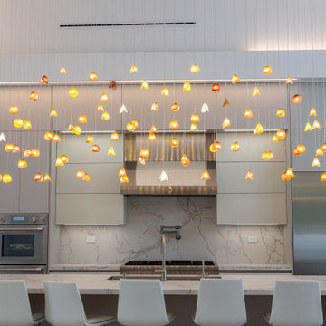 Statement Glass Lighting Spanning a Wide Kitchen Island