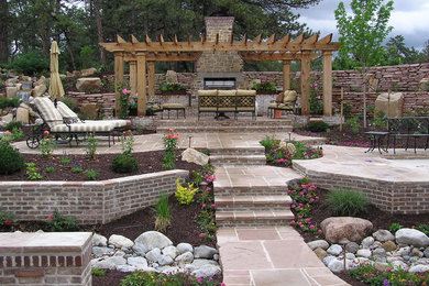 Design ideas for a large craftsman full sun backyard stone landscaping in Denver for spring.