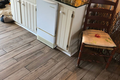 Example of a mid-sized classic enclosed brown floor and porcelain tile family room design in Charleston