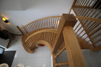 Oak helical stair with custom mirrow spindles