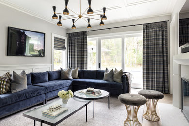 Inspiration for a large transitional beige floor living room remodel in New York with gray walls, a wall-mounted tv, a standard fireplace and a plaster fireplace
