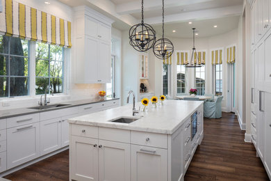 This is an example of a large transitional u-shaped separate kitchen in Jacksonville with an undermount sink, shaker cabinets, white cabinets, marble benchtops, white splashback, subway tile splashback, stainless steel appliances, dark hardwood floors and with island.
