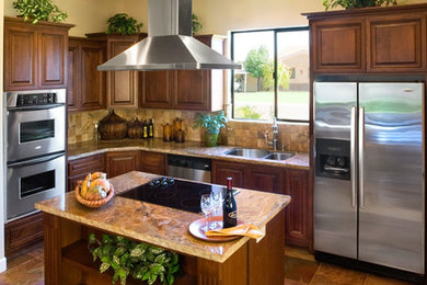 Inspiration for a large modern u-shaped slate floor and beige floor eat-in kitchen remodel in Phoenix with beige backsplash, ceramic backsplash, an island, a double-bowl sink, raised-panel cabinets, dark wood cabinets, stainless steel appliances and beige countertops