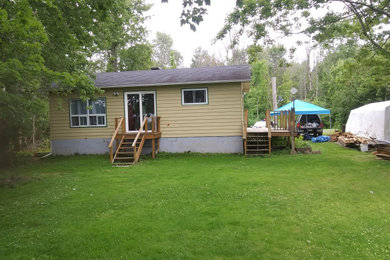 Inspiration for a large transitional backyard wood railing deck remodel in Ottawa
