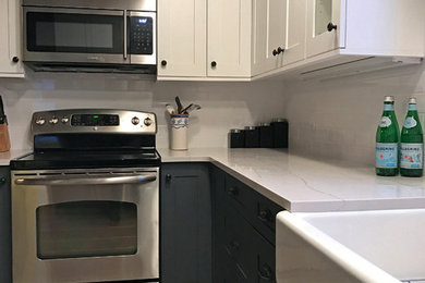 Mid-sized country single-wall vinyl floor eat-in kitchen photo in Seattle with a farmhouse sink, shaker cabinets, white cabinets, quartzite countertops, white backsplash, subway tile backsplash, stainless steel appliances and no island