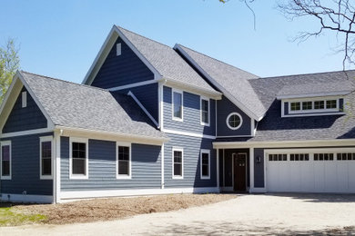 Large transitional blue two-story wood exterior home idea in Milwaukee with a shingle roof