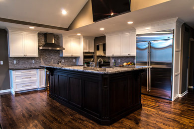 Inspiration for a transitional eat-in kitchen remodel in Detroit with flat-panel cabinets, white cabinets and an island