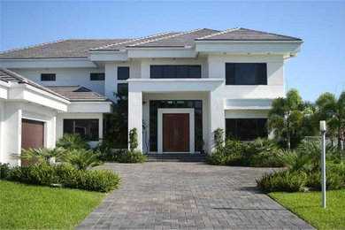 Huge contemporary white two-story stucco exterior home idea in New York