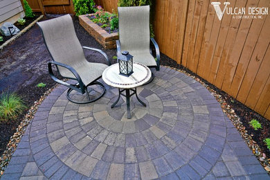 Inspiration for a small contemporary backyard patio in Portland with brick pavers and a gazebo/cabana.